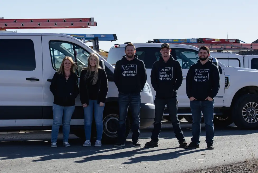 The Columbia Basin Satellite & Electric crew in front of their service vans